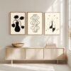 Three framed artworks featuring abstract vases and floral designs in black and white on a light background.