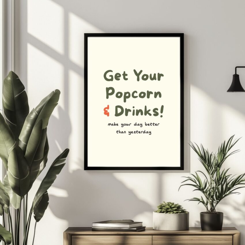 movie-art-prints-2-scaled-1.jpg Framed wall art with the text 'Get Your Popcorn & Drinks! make your day better than yesterday' in a modern design.