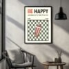 movie-art-prints-4-scaled-1.jpg Framed print with the text 'BE HAPPY' and a graphic of a striped drink cup on a checkered background.