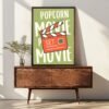 Framed art print featuring a movie clapperboard with the words 'Popcorn Movie Set' on a green background, displayed on a wooden console table.