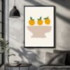 Art print featuring three orange fruits with green leaves on a neutral background, displayed in a simple bowl shape.